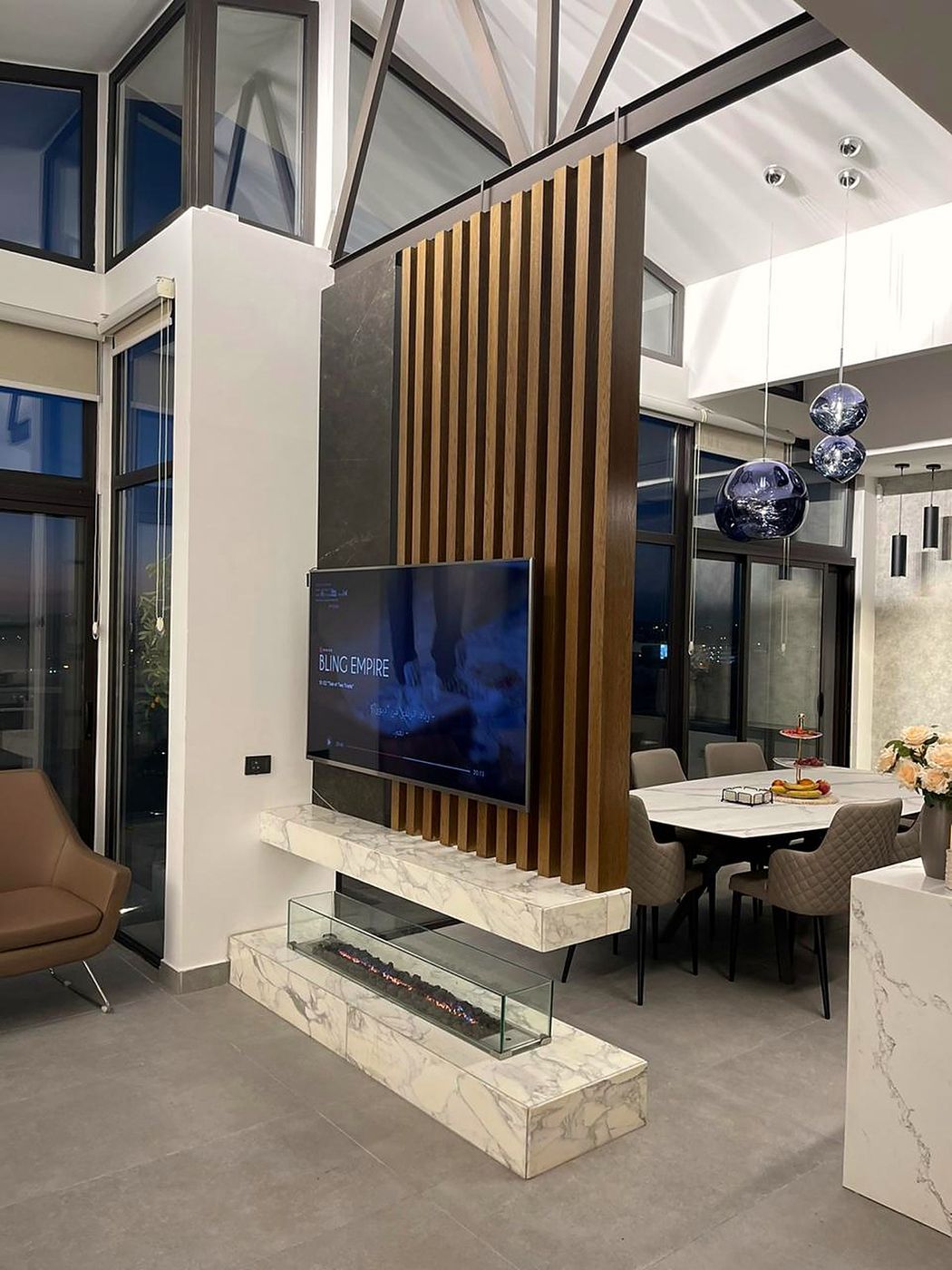 Living room with timber slats and fireplace